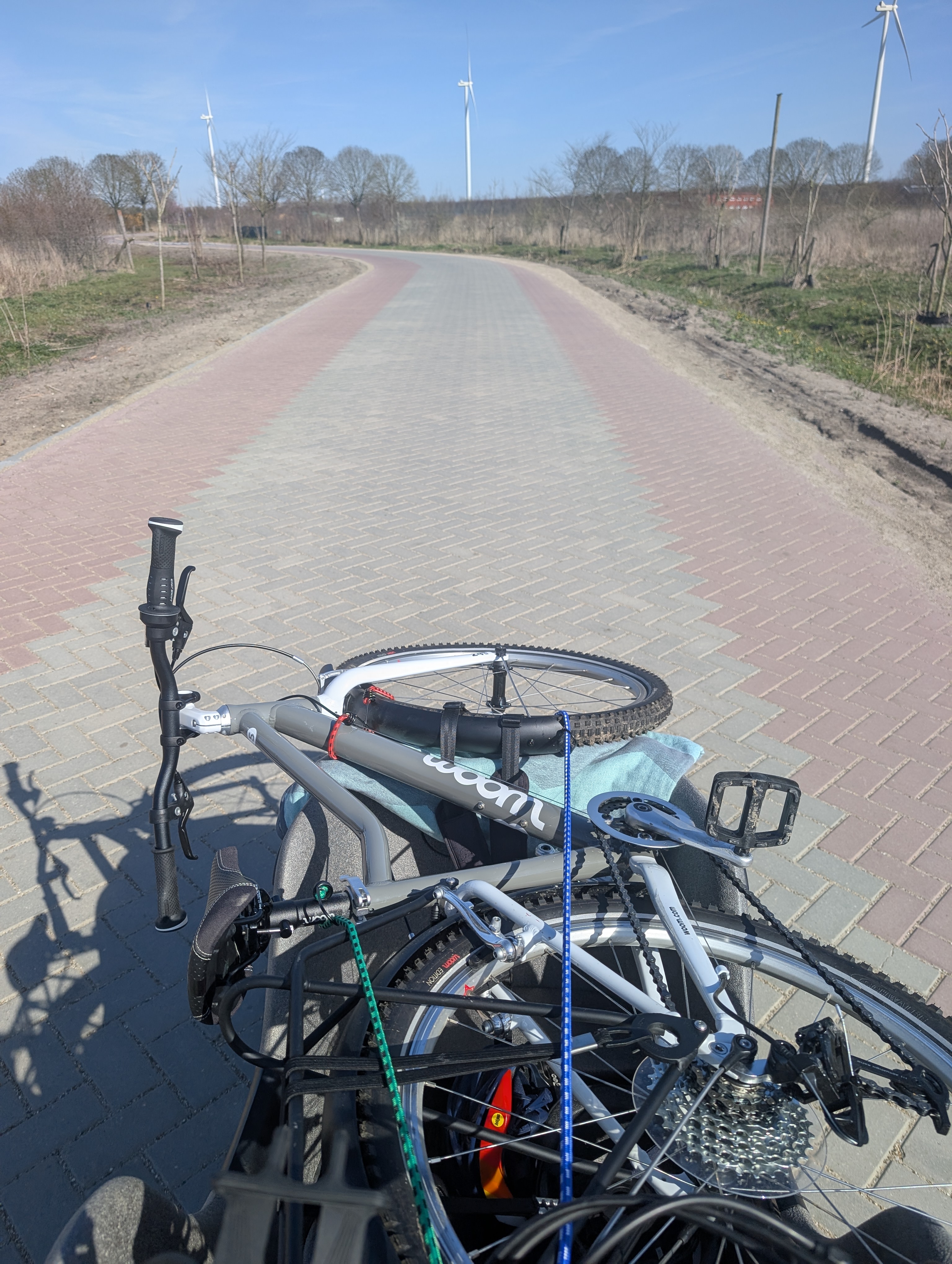 a cargo bike with a kids bike on top
