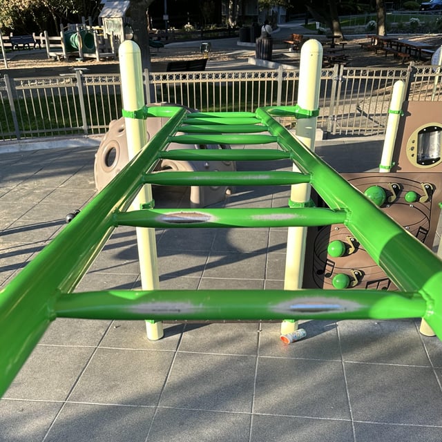 monkey bars where the first bar has more wear right than left. second bar the other way around. third bar almost no wear