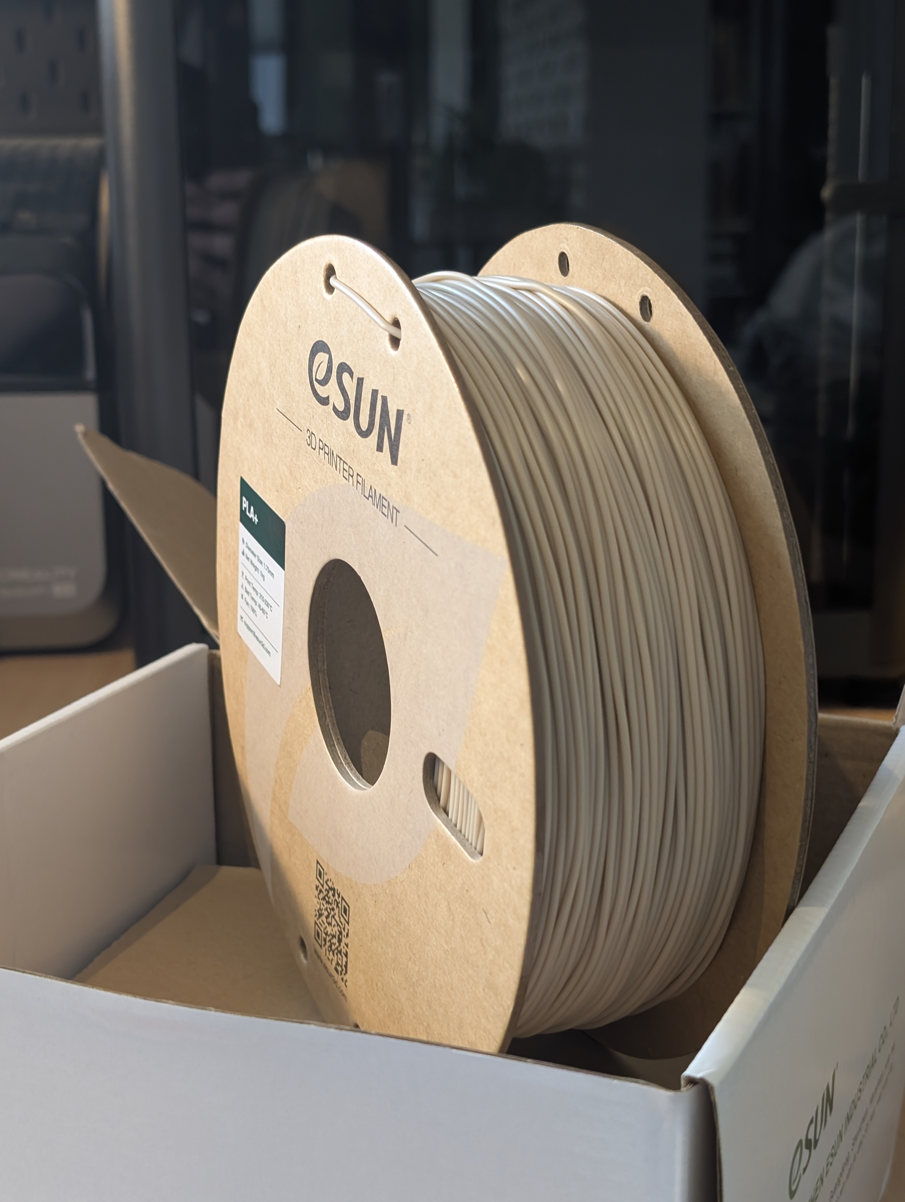 A role of filament for a 3d printer in an off-white colour.