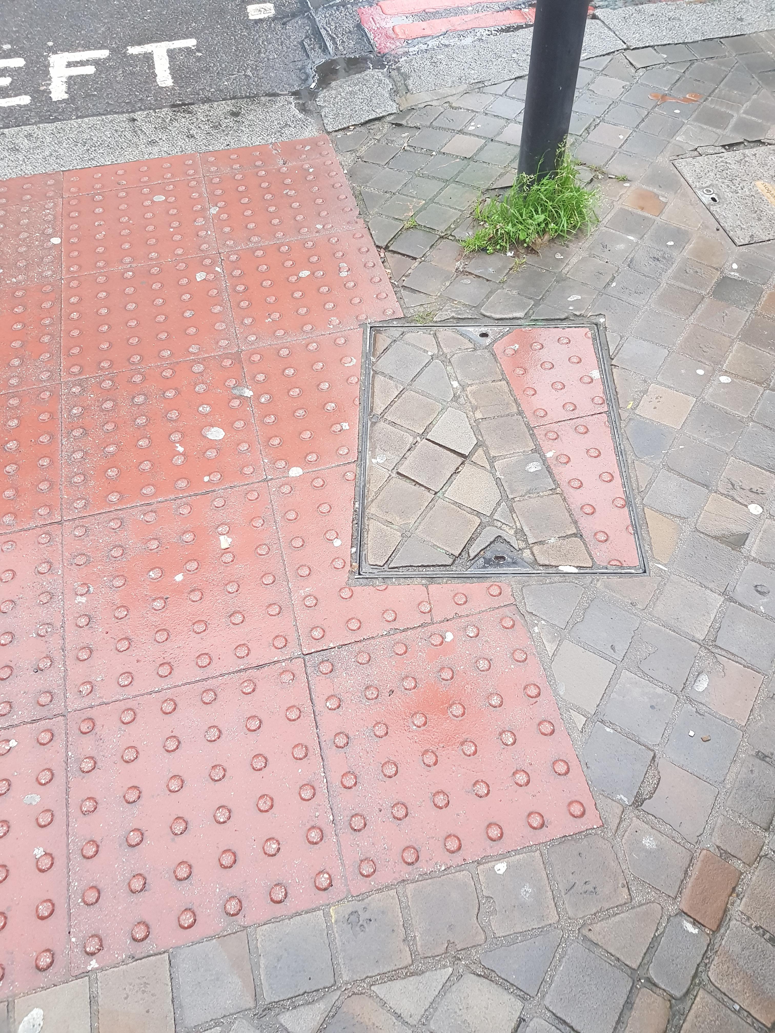 A picture of tactile paving where a rectangle shape was taken out and rotated. The pattern is ruined.